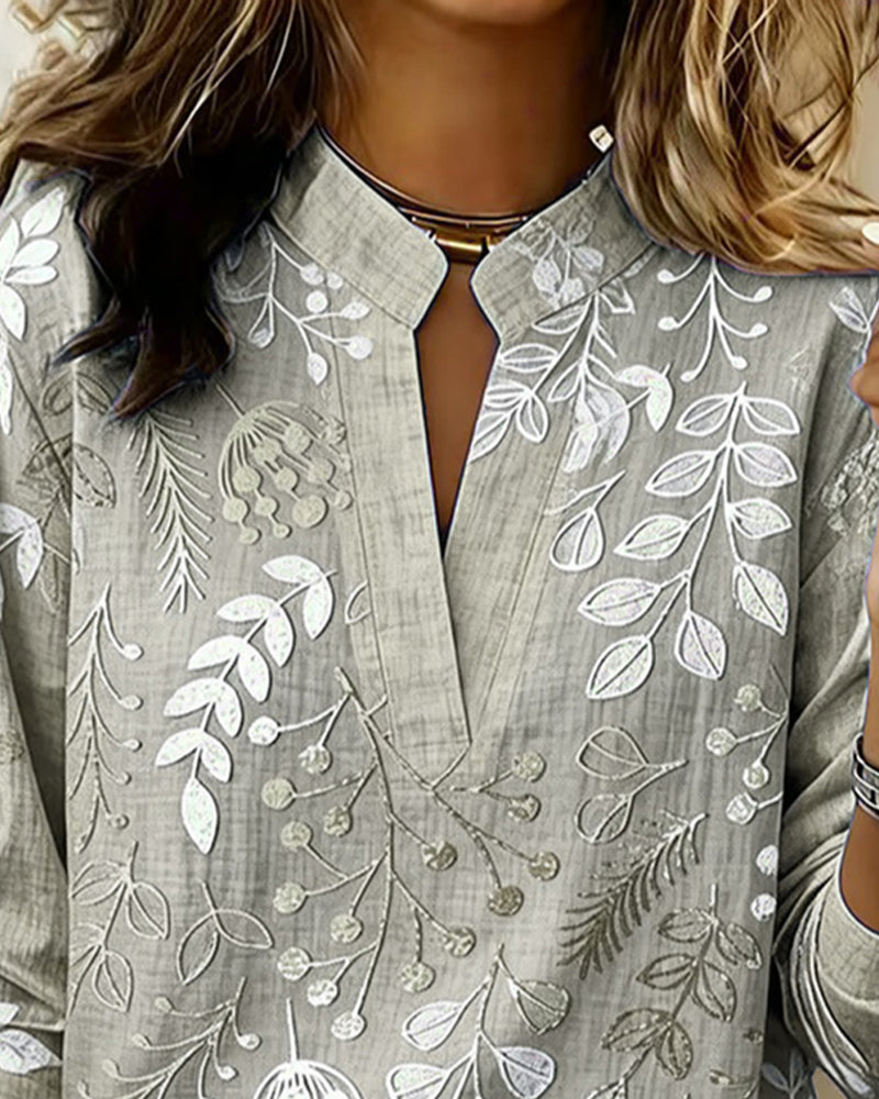 Almudena - Blusa con estampado floral y cuello alto.