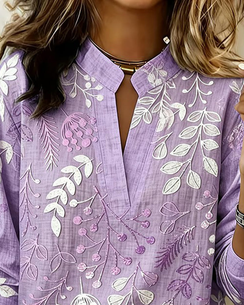 Almudena - Blusa con estampado floral y cuello alto.