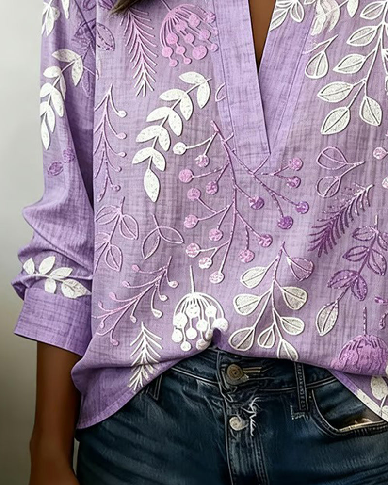 Almudena - Blusa con estampado floral y cuello alto.